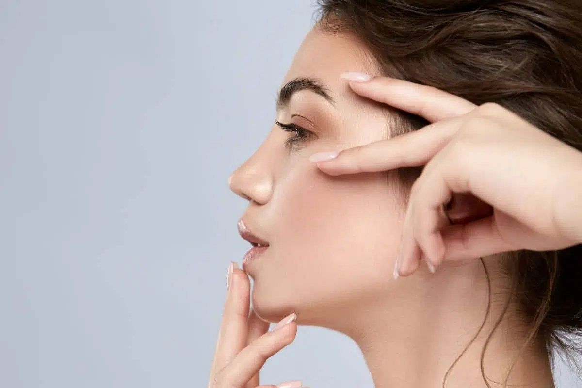 Close-up side view of woman highlighting smooth nose contour from non-surgical liquid rhinoplasty treatment.