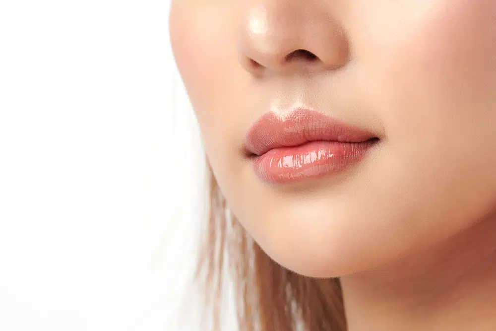 Close-up of enhanced lips illustrating differences between lip filler and lip lift procedures.